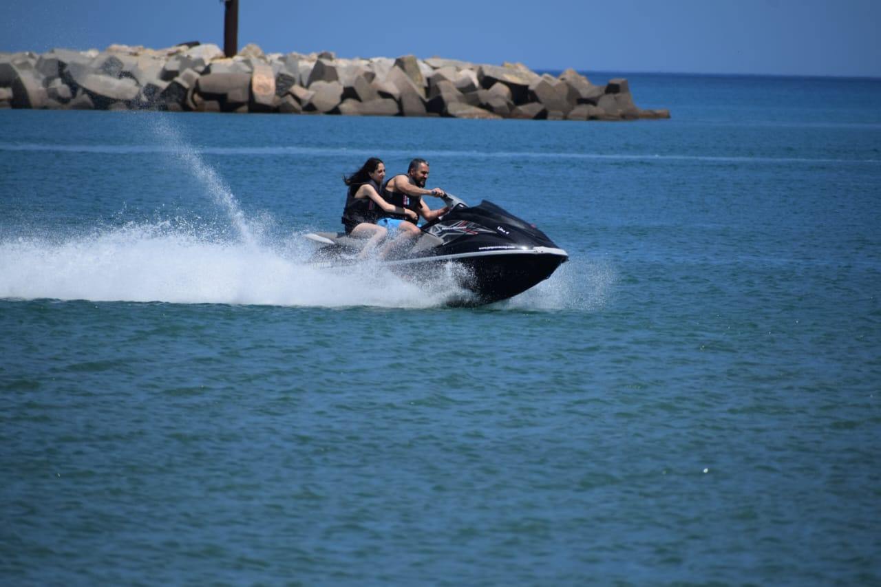 Yamaha jet ski at full speed with two riders off Yasmine Hammamet