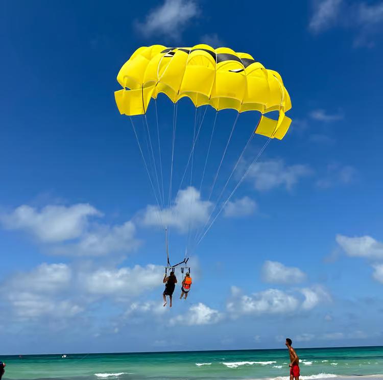 A tandem flight on a yellow parasail over the turquoise sea off Hammamet