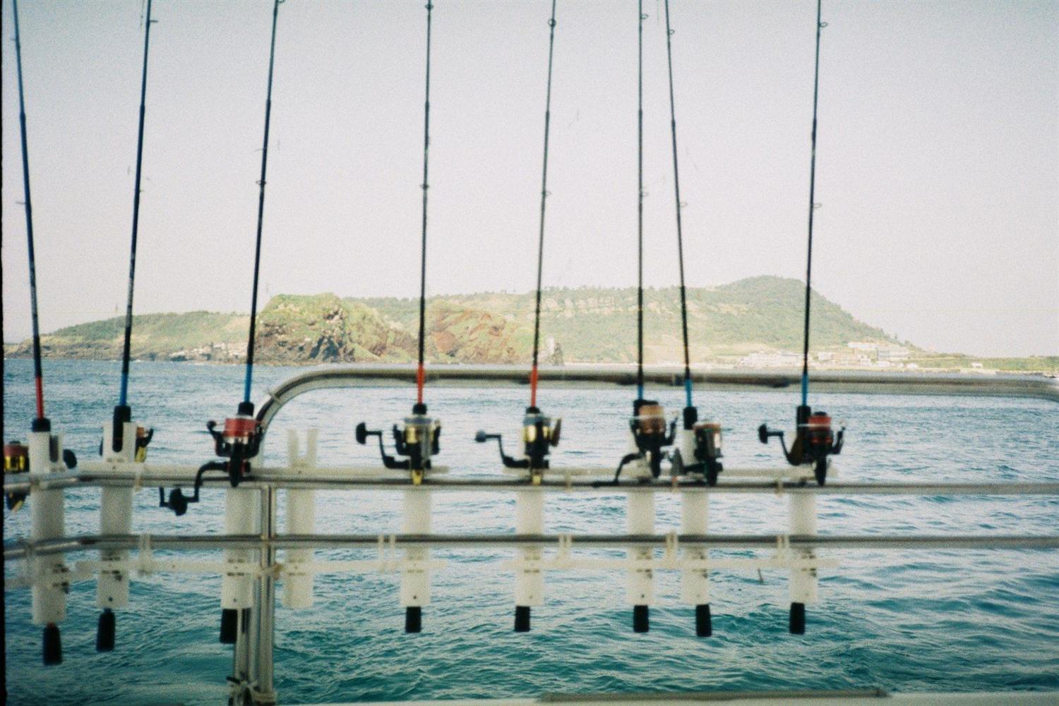 A fishing rod cast from the stern of a boat out at sea
